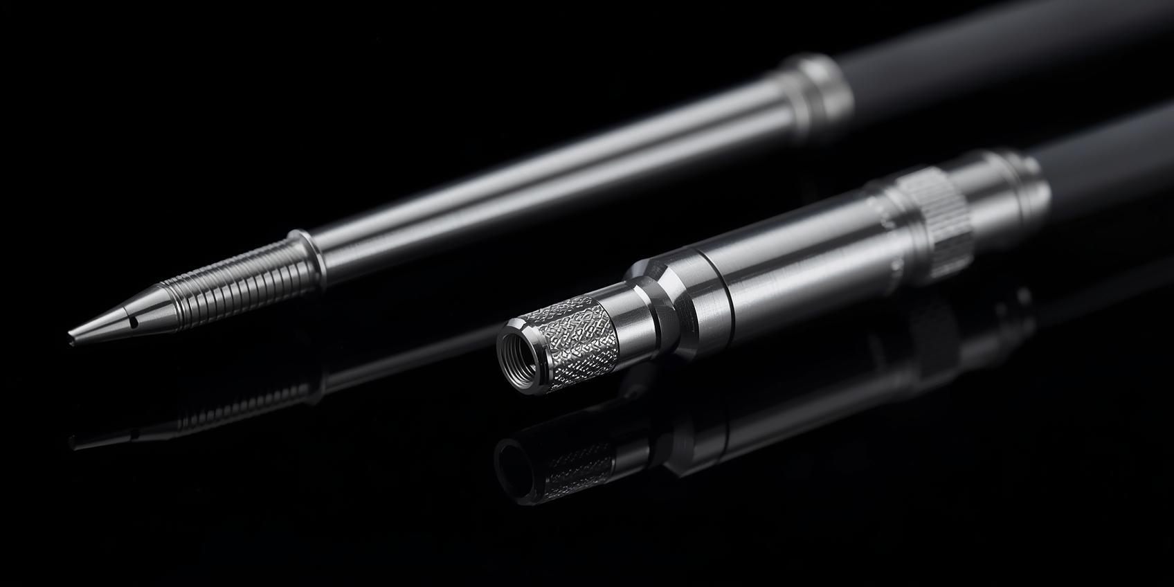 Macro photos of precision-machined catheter parts with a dark background